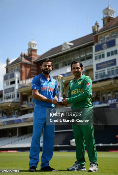 India captain Virat Kohli and Pakistan captain Sarfraz Ahmed hold the ICC Champions Trophy ahead of tomorrow's final at The Kia Oval on June 17, 2017...
