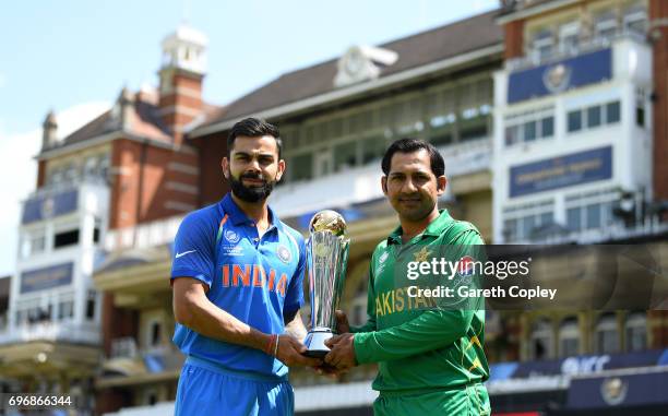 India captain Virat Kohli and Pakistan captain Sarfraz Ahmed hold the ICC Champions Trophy ahead of tomorrow's final at The Kia Oval on June 17, 2017...