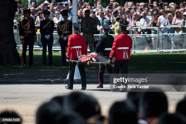 Guardsman is carried off on a stretcher after fainting during the annual Trooping The Colour parade in Horse Guards Parade on June 17, 2017 in...