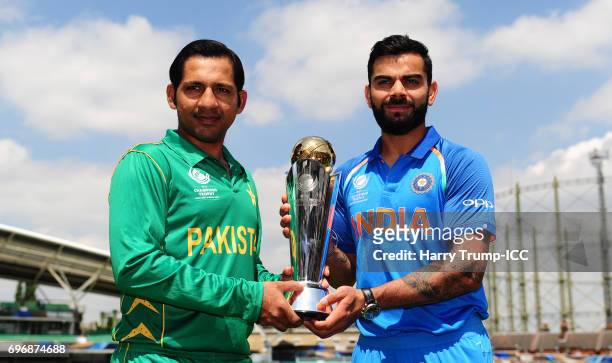 Virat Kohli, Captain of India and Sarfraz Ahmed, Captain of Pakistan pose with the trophy during the Previews - ICC Champions Trophy Final at The Kia...