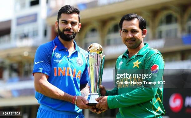 Virat Kohli, Captain of India and Sarfraz Ahmed, Captain of Pakistan pose with the trophy during the Previews - ICC Champions Trophy Final at The Kia...