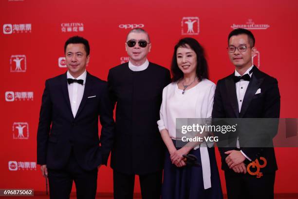 Huayi Brothers Media Corp. CEO Wang Zhonglei and director Feng Xiaogang arrive at the red carpet of the 20th Shanghai International Film Festival on...