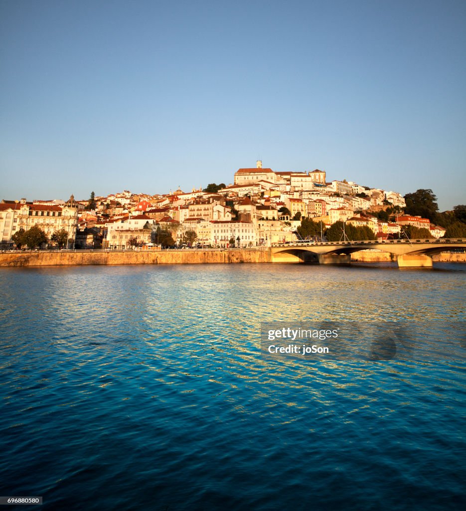Twilight view of medieval city centre across Mondego river