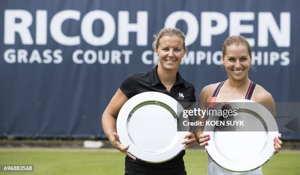 Dominika Cibulkova of Slovakia and Kirsten Flipkens of Belgium pose with their trophy after winning the ladies double tennis final match at the Ricoh...