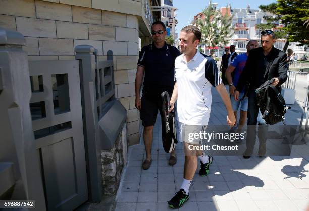 French President Emmanuel Macron dressed in tennis player returns to his house on the eve of the second round of the French parliamentary elections...