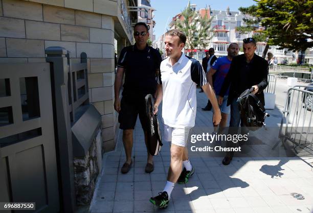 French President Emmanuel Macron dressed in tennis player returns to his house on the eve of the second round of the French parliamentary elections...