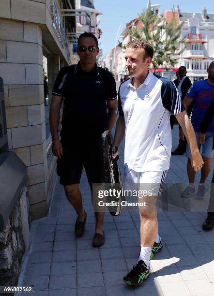 French President Emmanuel Macron dressed in tennis player returns to his house on the eve of the second round of the French parliamentary elections...