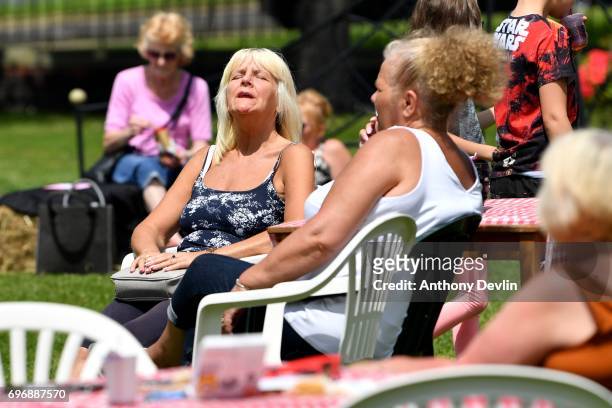 Woman enjoys the warm weather as people attend a Great Get Together event in memory of murdered MP Jo Cox on June 17, 2017 in Heckmondwike, England....