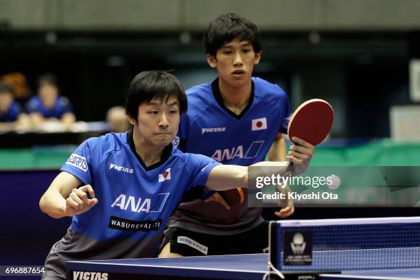 Koki Niwa and Maharu Yoshimura of Japan compete in the Men's Doubles final match against Ma Long and Xu Xin of China during day four of the 2017 ITTF...