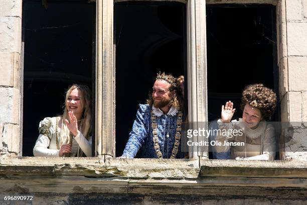 Actors who are playing during the Crown Prince's visit to Kronborg Castle wave from a window to Japanese Crown Prince Naruhito during his visit to...