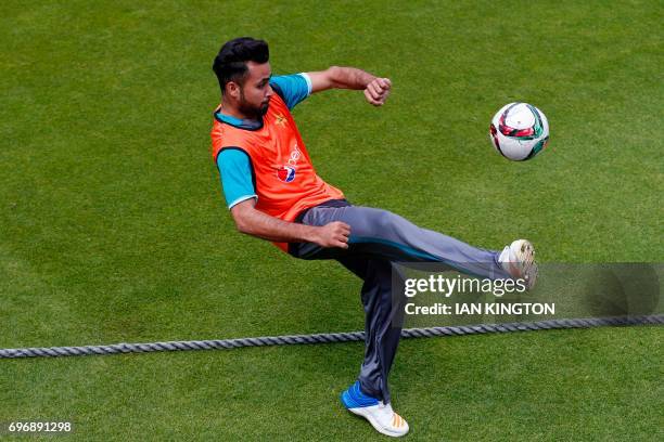 Pakistan's Fahim Ashraf plays football during a nets practice session at The Oval in London on June 17 on the eve of the ICC Champions Trophy Final...