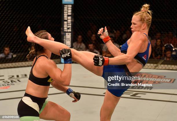 Holly Holm knocks out Bethe Correia of Brazil with a kick in their women's bantamweight bout during the UFC Fight Night event at the Singapore Indoor...