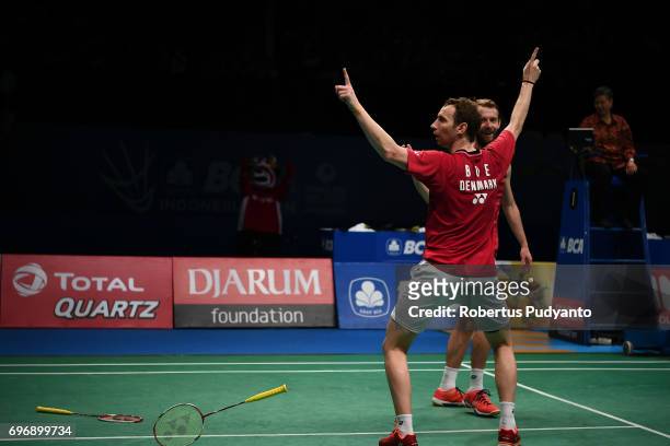 Mathias Boe and Carsten Mogensen of Denmark celebrate victory after beating Fajar Alfian and Muhammad Rian Ardianto of Indonesia during Mens Double...