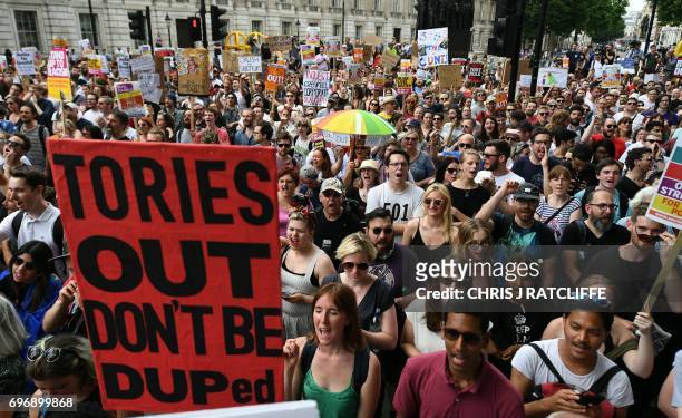Demonstrators hold placards and chant during an anti-Conservative Party Leader and Britain's Prime Minister Theresa May, and Democratic Unionist...