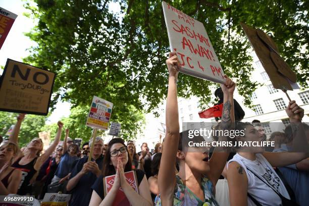 Demonstrators hold placards and chant during an anti-Conservative Party Leader and Britain's Prime Minister Theresa May, and Democratic Unionist...