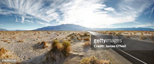 empty road in desert landscape with distant mountains panoramic - panoramic sky stock pictures, royalty-free photos & images