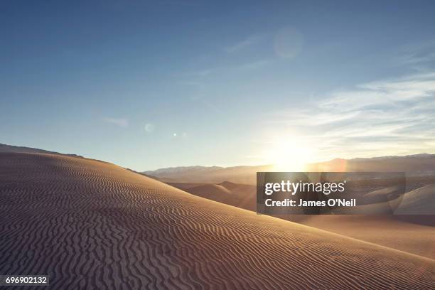 sunset over rolling sand dunes - desert sky stock pictures, royalty-free photos & images