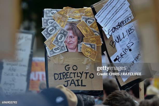 Demonstrators hold placards and chant during an anti-Conservative Party Leader and Britain's Prime Minister Theresa May, and Democratic Unionist...