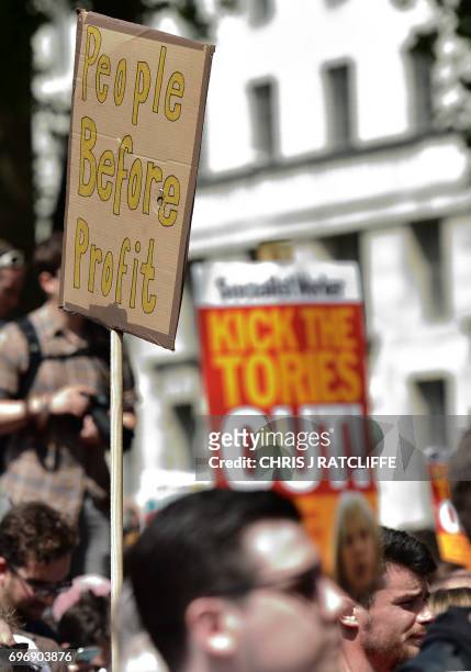 Demonstrators hold placards and chant during an anti-Conservative Party Leader and Britain's Prime Minister Theresa May, and Democratic Unionist...