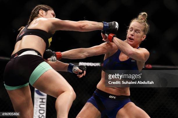 Holly Holm of United States fights Bethe Correia of Brazil in the WomenÕs Bantamweight Main Event Bout during UFC Singapore Fight Night at Singapore...