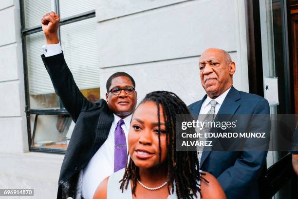 Bill Cosby looks on as Andrew Wyatt, his spokesperson celebrates as they exit the courthouse after a mistrial on the sixth day of jury deliberations...