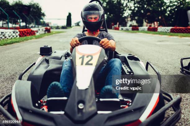 mid adult man go-karts - car racing helmet stock pictures, royalty-free photos & images