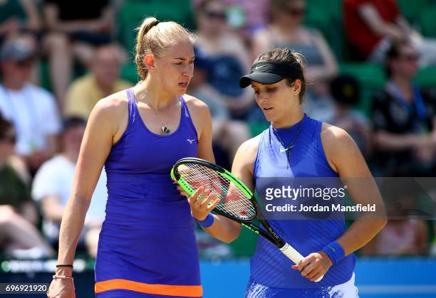 Jocelyn Rae and Laura Robson of Great Britain talk during their Women's Doubles match against Heather Watson of Great Britain and Christina McHale of...