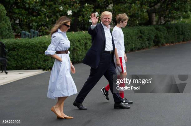 President Donald J. Trump walks to Marine One with first lady Melania Trump and their son Barron Trump, as they depart the White House for Camp...