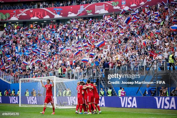 Denis Glushakov of Russia celebrates with team mates after scoring a goal during a group A match between Russia and New Zealand at Saint Petersburg...