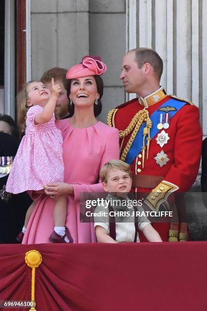 Britain's Catherine, Duchess of Cambridge , and Britain's Prince William, Duke of Cambridge, stand on the balcony of Buckingham Palace to watch a...