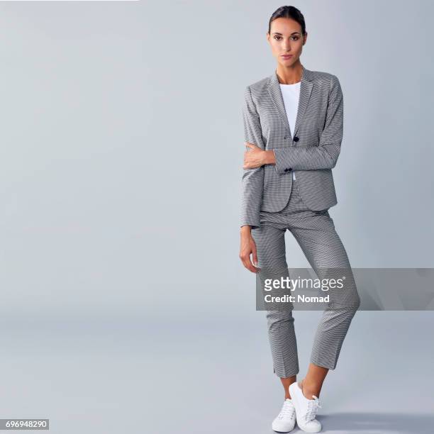 full length of confident businesswoman holding arm - full length stock pictures, royalty-free photos & images