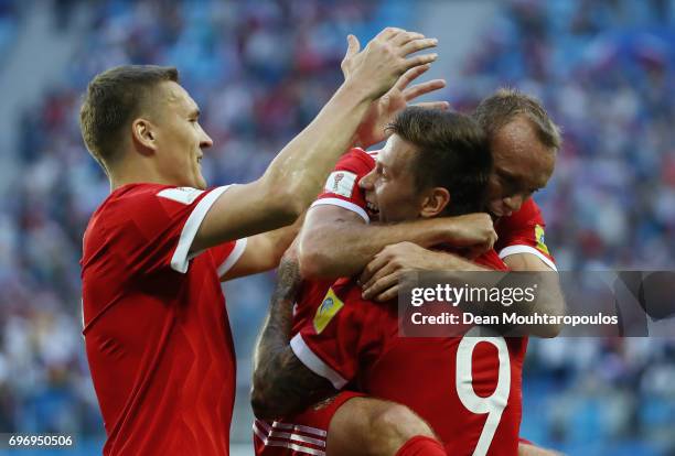 Fedor Smolov of Russia celebrates scoring his sides second goal with his team mates Aleksandr Bukharov and Dennis Glushakov during the FIFA...