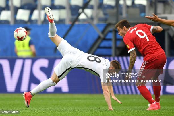 New Zealand's defender Kip Colvey vies for the ball against Russia's forward Fedor Smolov during the 2017 Confederations Cup group A football match...