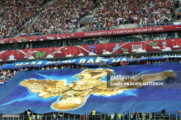 Huge flag with an image of the Russian double-headed eagle is held up by fans at the start of the 2017 Confederations Cup group A football match...