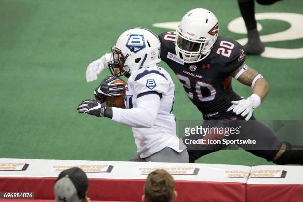 Baltimore Brigade WR Brandon Tompkins eludes the tackle attempt of Cleveland Gladiators DB Kenny Veal as he scores on a 40-yard pass play during the...