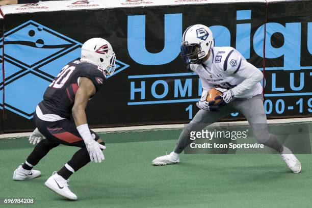 Baltimore Brigade WR Julian Talley is defended by Cleveland Gladiators DB Kenny Veal after catching a pass during the fourth quarter of the Arena...