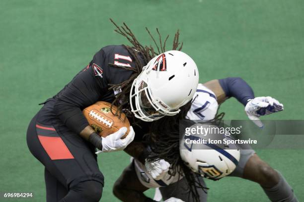 Cleveland Gladiators WR Phillip Barnett is tackled by Baltimore Brigade DB Josh Victorian after making a catch during the fourth quarter of the Arena...