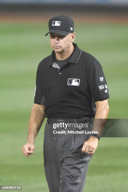 Umpire Andy Fletcher looks on during a baseball game between the Washington Nationals and the Atlanta Braves at Nationals Park on June 13, 2017 in...