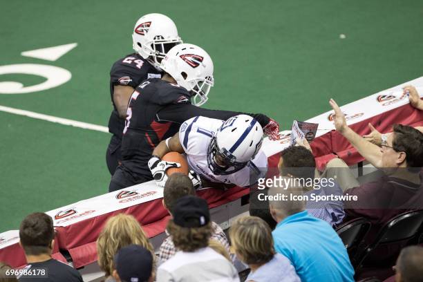 Cleveland Gladiators DB Fredrick Obi tackles Baltimore Brigade WR/DB Reggie Gray into the wall during the third quarter of the Arena League Football...