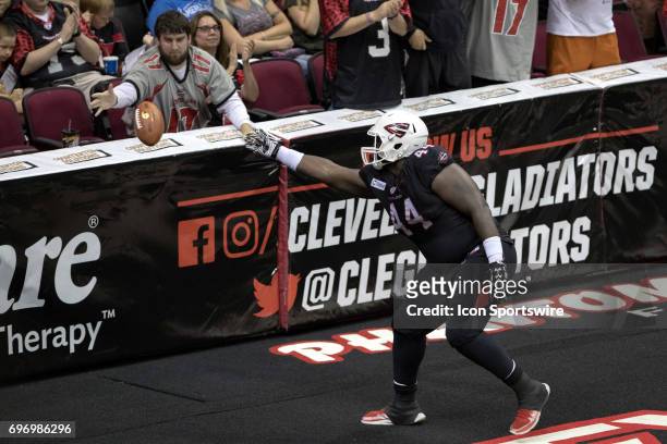 Cleveland Gladiators OL Phillipkeith Manley flips the football into the stands after making an 8-yard touchdown catch during the third quarter of the...