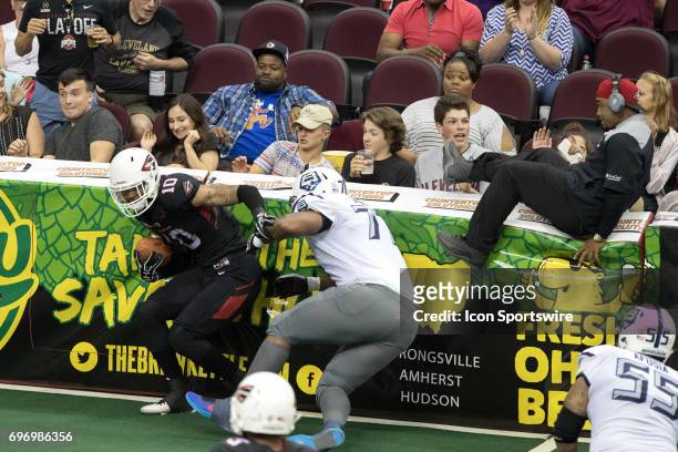 Cleveland Gladiators WR Lonnie Outlaw is tackled by Baltimore Brigade OL Ian Joseph after making an interception return during the third quarter of...