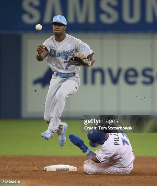 Tim Anderson of the Chicago White Sox turns a double play in the sixth inning during MLB game action as Kevin Pillar of the Toronto Blue Jays slides...