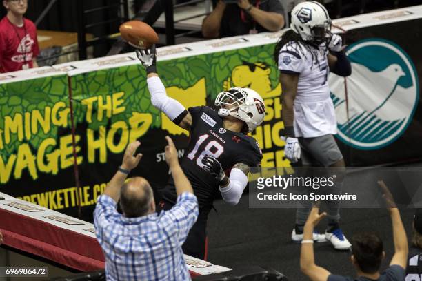 Cleveland Gladiators WR Quentin Sims throws the ball into the stands after making a 23-yard touchdown catch during the third quarter of the Arena...