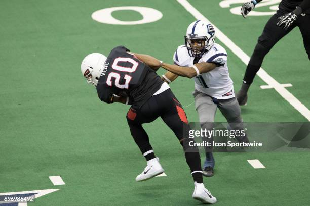 Cleveland Gladiators DB Kenny Veal is tackled by Baltimore Brigade WR Reggie Gray as he returns an interception during the third quarter of the Arena...