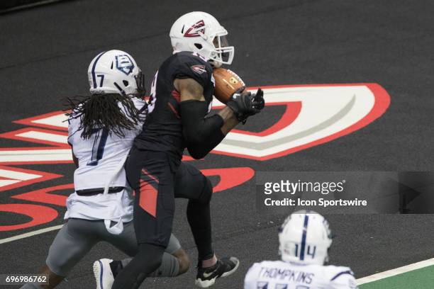 Cleveland Gladiators WR Michael Preston pulls in a 8-yard touchdown pass as Baltimore Brigade DB Josh Victorian defends during the third quarter of...