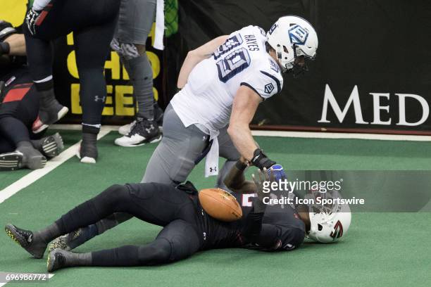 Cleveland Gladiators QB Arvell Nelson is on the turn after being tackled by Baltimore Brigade LB Robert Hayes during the third quarter of the Arena...