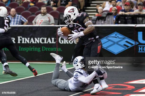 Cleveland Gladiators DB Kenny Veal is tackled by Baltimore Brigade WR Julian Talley as he returns a kickoff during the second quarter of the Arena...