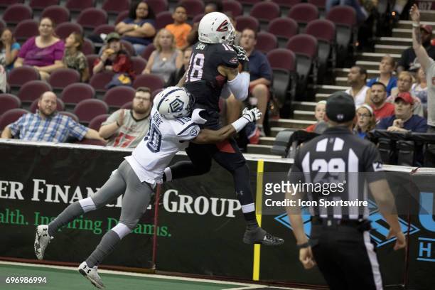 Cleveland Gladiators WR Quentin Sims makes a 25-yard touchdown catch as Baltimore Brigade DB Varmah Sonie defends during the first quarter of the...