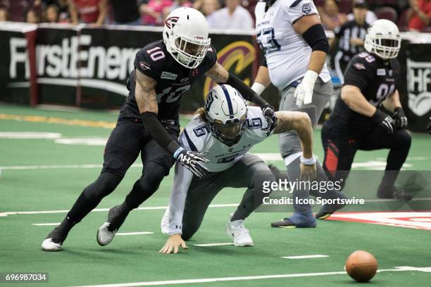 Cleveland Gladiators WR Lonnie Outlaw and Baltimore Brigade QB Shane Carden go after the football after Carden fumbled during the first quarter of...