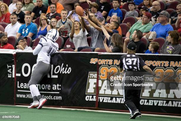 Fans reach for the football after it went off the hands of Baltimore Brigade WR Brandon Tompkins during the first quarter of the Arena League...